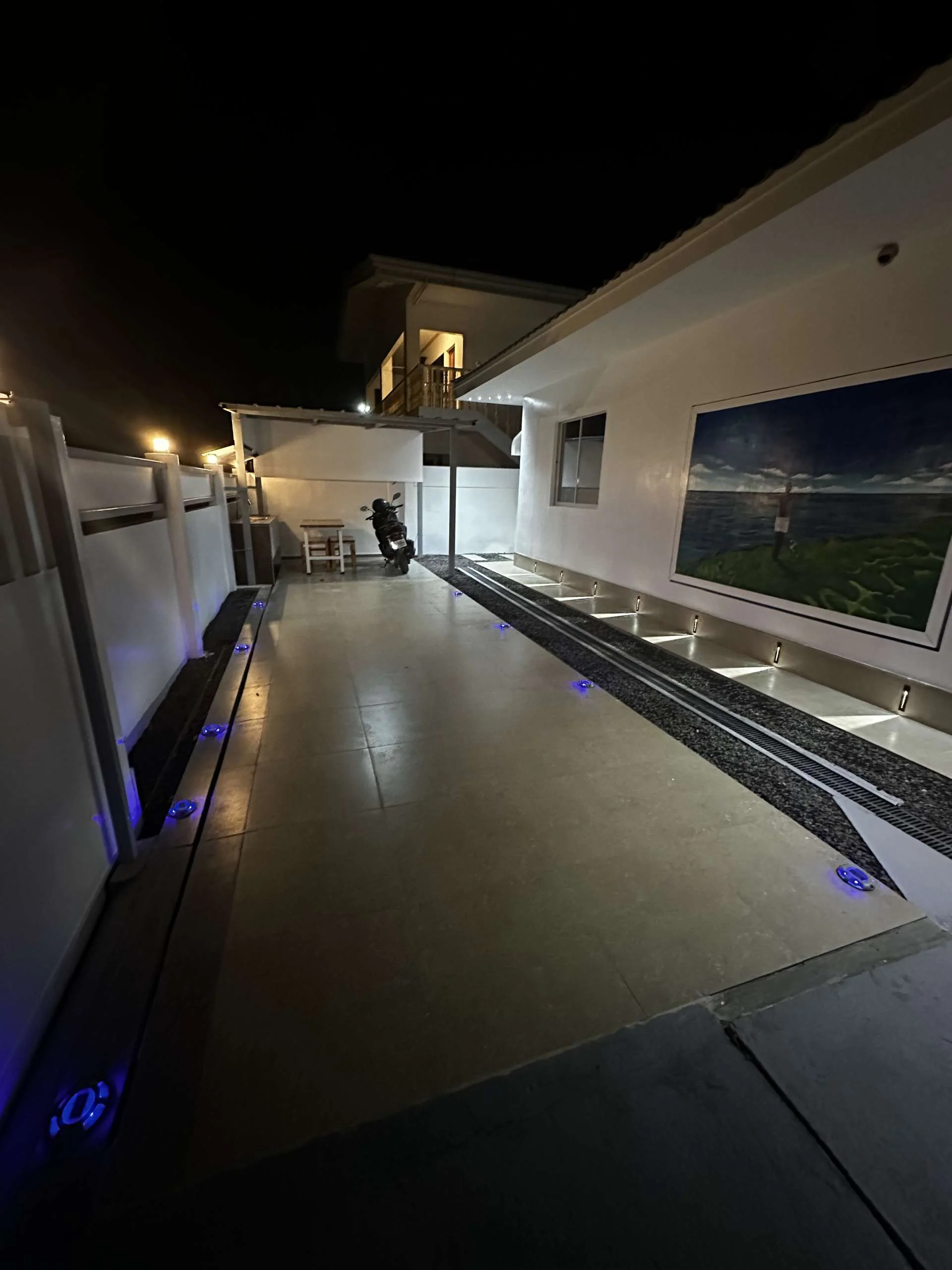 Hero House bantayan parking area in night with few light