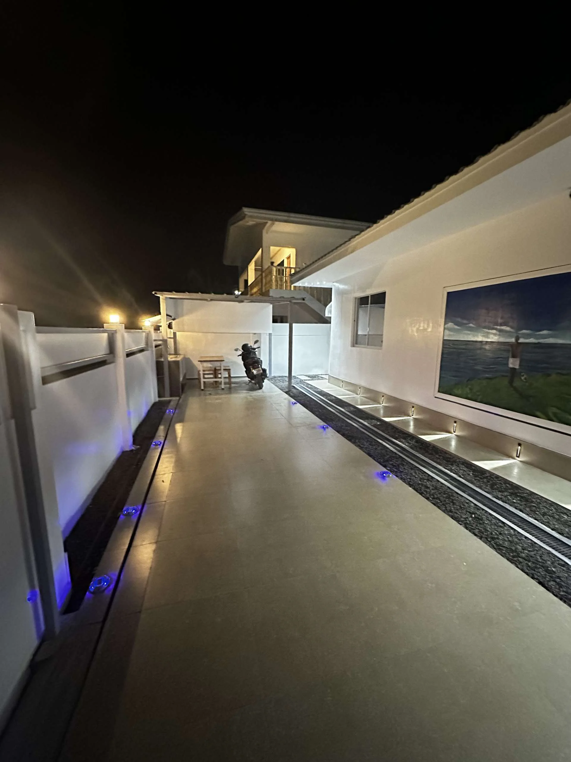 Hero House Bantayan parking area in the night with light and with entrance gate view