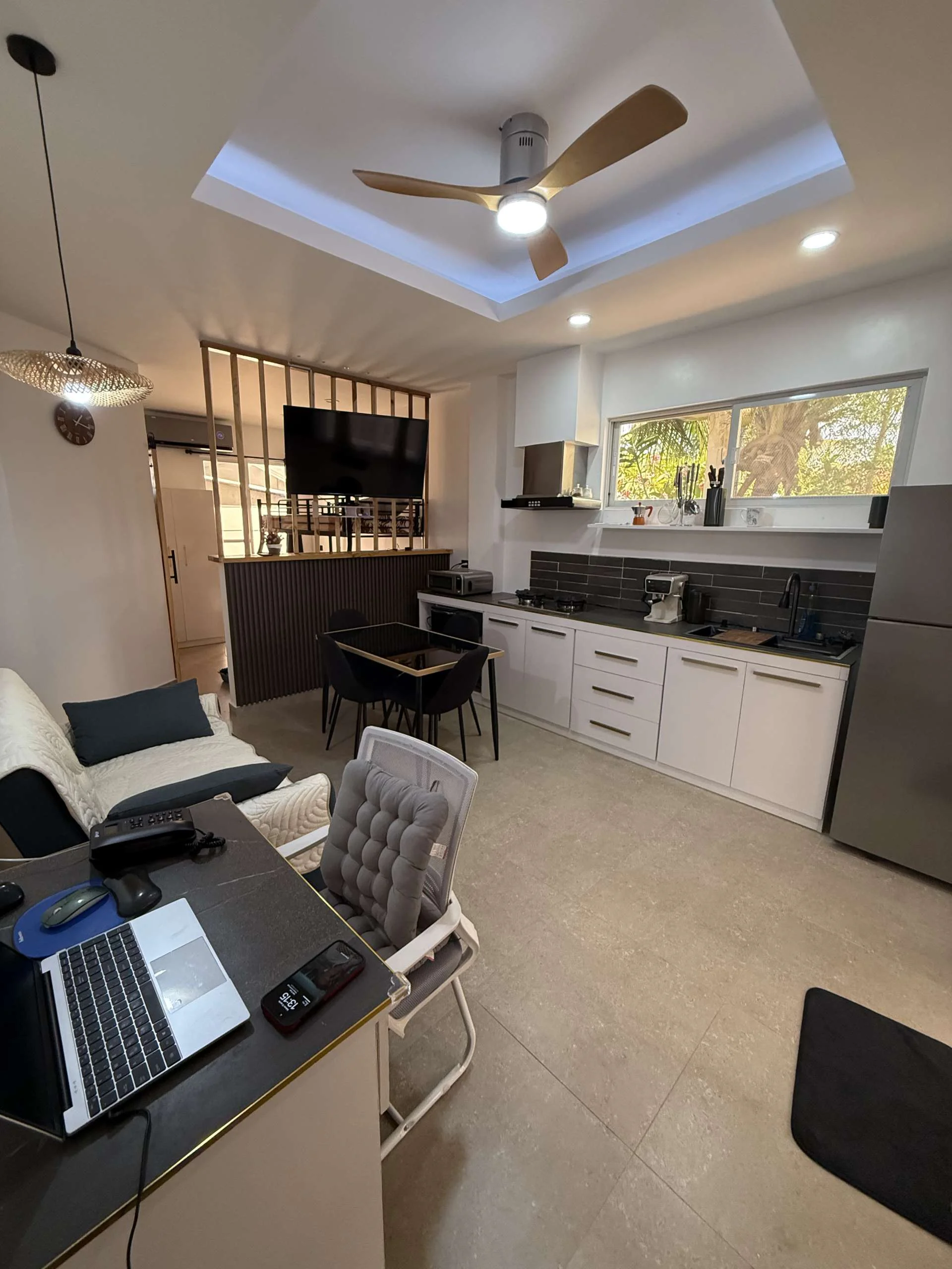 Living room and kitchenette in Papaya Apartment at Hero House Santa fe