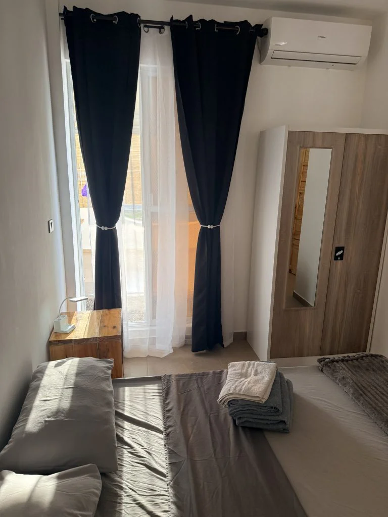 Hero house Bantayan bedroom, where you will stay It consists of a double bed, wardrobe and bedside table, windows view