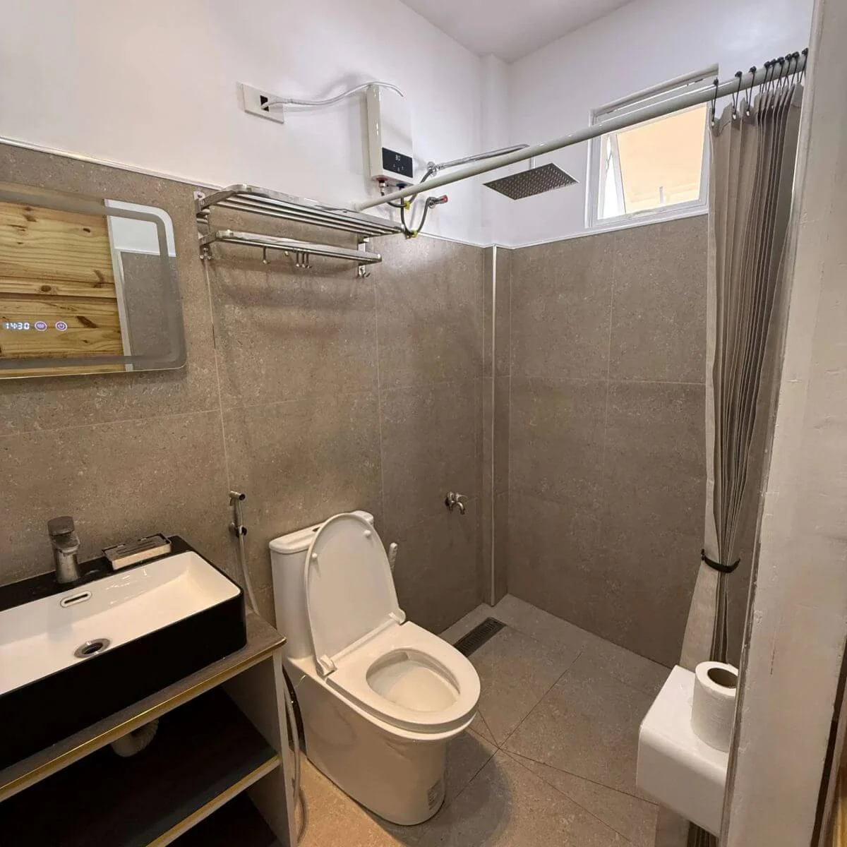 Bathroom detail featuring a sink, shower, and flush-entry floor with no step.
