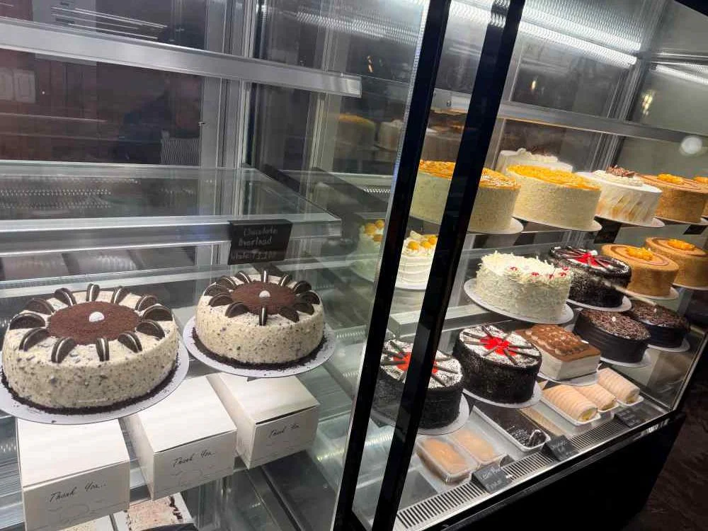 Cakes and desserts display at Kermit's Café, Bantayan Town