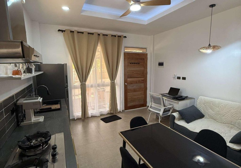 Living room and kitchenette in Papaya Apartment at Hero House Bantayan